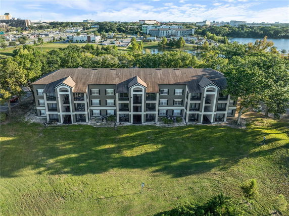 Front view of a multi-story residential building with large balconies.