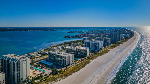 Panoramic view of beachfront buildings and coastline along the ocean.