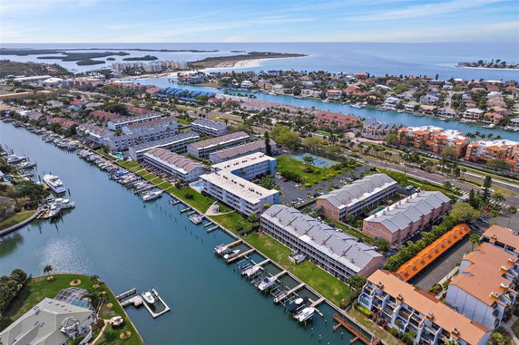 Aerial panoramic view of a coastal residential area with canals and boats.