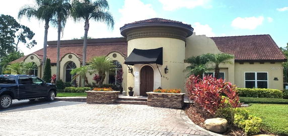 Front view of a house with a circular entrance and tile roof.