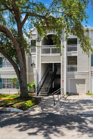 Front view of a multi-story building with exterior stairs.