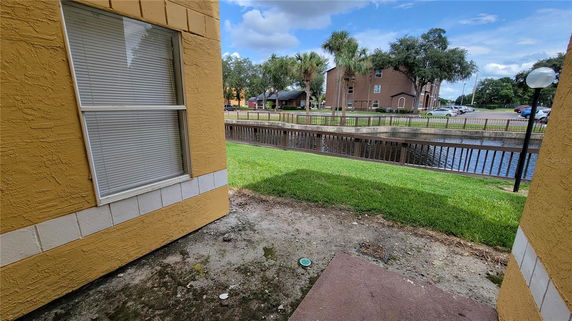 View from a building showing adjacent canal, grassy area, and surrounding buildings.