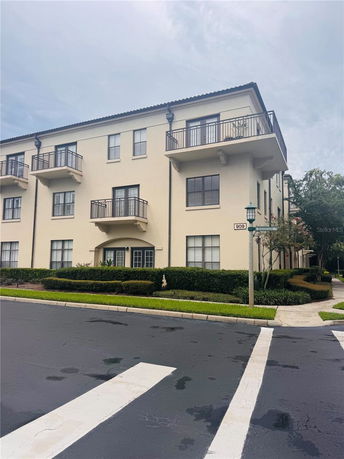 Front view of a multi-story building with balconies.