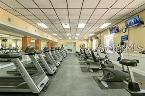 Gym area with multiple treadmills and exercise equipment in a club house.