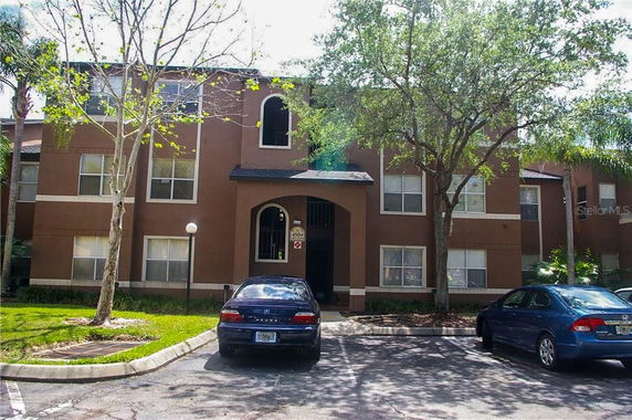 Front view of a multi-story residential building with a central entrance.