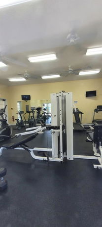Interior view of a gym area with exercise equipment.