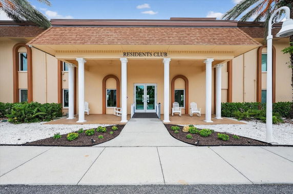 Front view of a residents club building with columns and double doors.