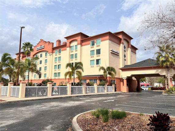 Front view of a multi-story hotel building with an archway and decorative entrance.