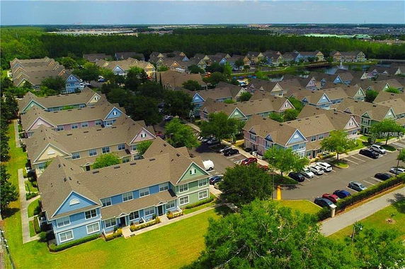 Aerial view of a residential area with multiple two-story houses and streets.