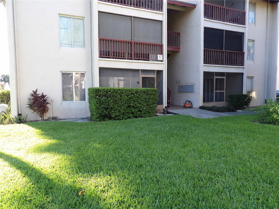 Front view of a multi-story building with screened balconies.
