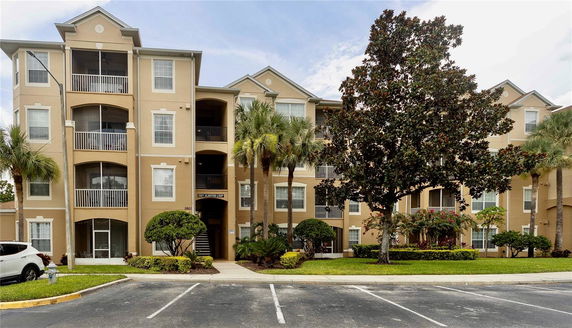 Front view of a multi-story apartment building with balconies.