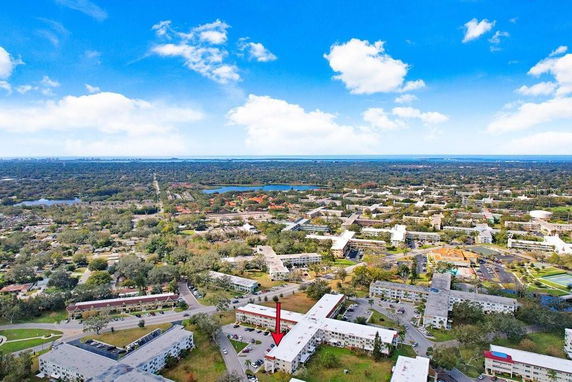 Aerial panoramic view of a residential area with multiple buildings and surrounding landscape.