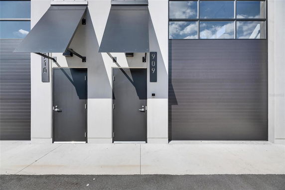 Front view of a building with two doors and metal awnings.