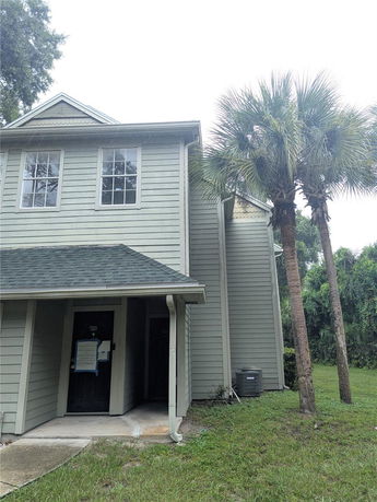 Front view of a two-story house with a gable roof and entrance porch.