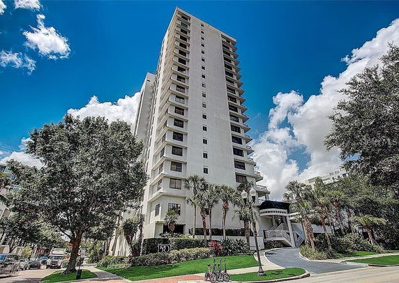 Front view of a tall residential building with multiple stories.