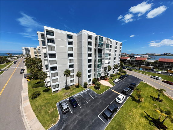 Front view of a multi-story residential building with balconies.