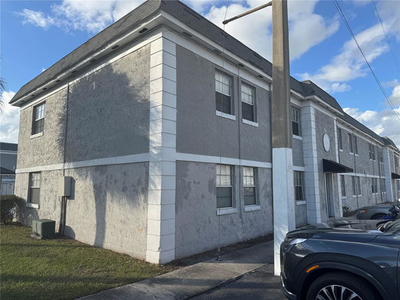 Front view of a two-story commercial building with a flat roof and multiple windows.