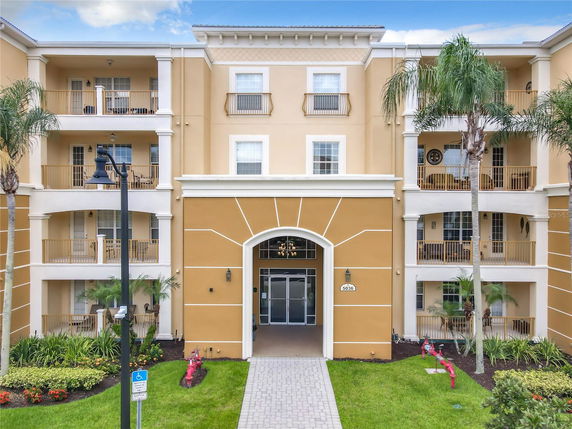 Front view of a multi-story apartment building with balconies.