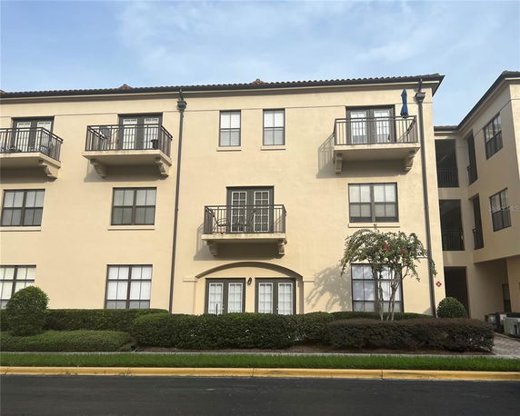 Front view of a three-story residential building with balconies.