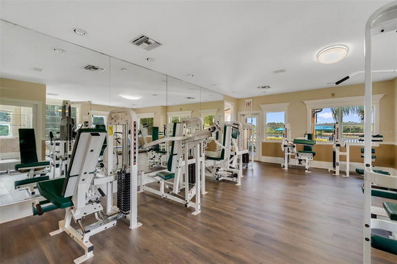 Indoor gym area with mirrored walls and fitness equipment.