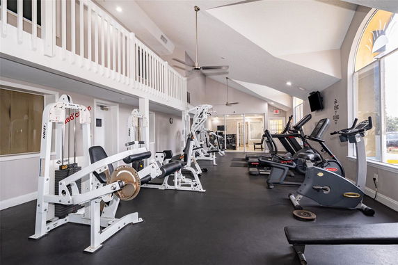 Interior view of a gym with exercise machines and treadmills.
