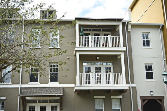 Front view of a multi-story residential building with balconies.