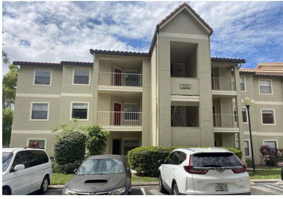 Front view of a three-story apartment building with balconies.
