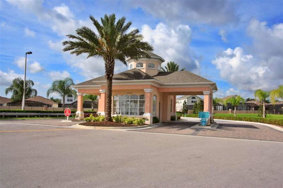 Front view of a small, peach-colored building with a drive-through area.
