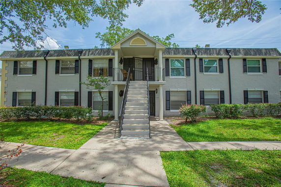 Front view of a two-story apartment building with a central staircase.