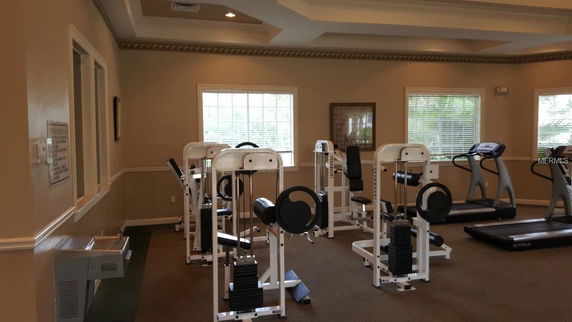 Indoor gym with exercise machines and treadmills.