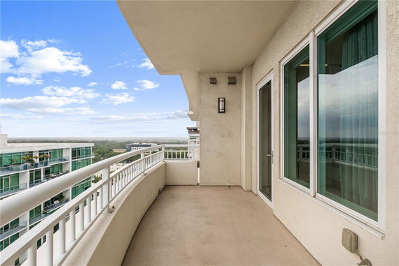 Balcony view overlooking surrounding areas and nearby buildings.