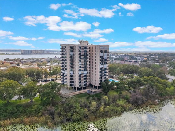 Front view of a multi-story apartment building in a scenic area.