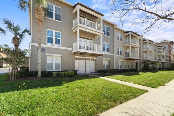 Front view of a three-story residential building with balconies.