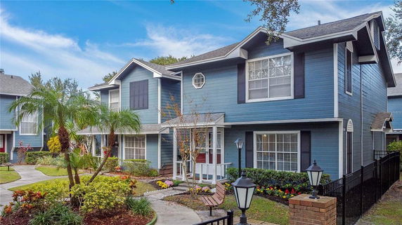 Front view of a two-story house with blue siding and white trim.
