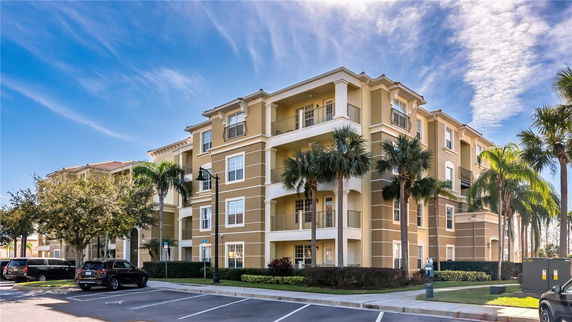 Front view of a multi-story apartment building with balconies.