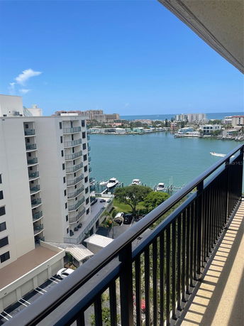 Panoramic view from a high-rise building overlooking a waterfront and surrounding areas.