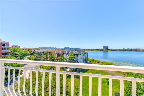 Panoramic view of buildings near a waterfront seen from a balcony.