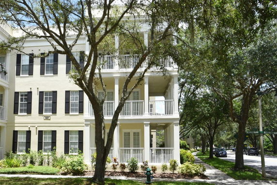 Front view of a multi-story building with balconies and columns.