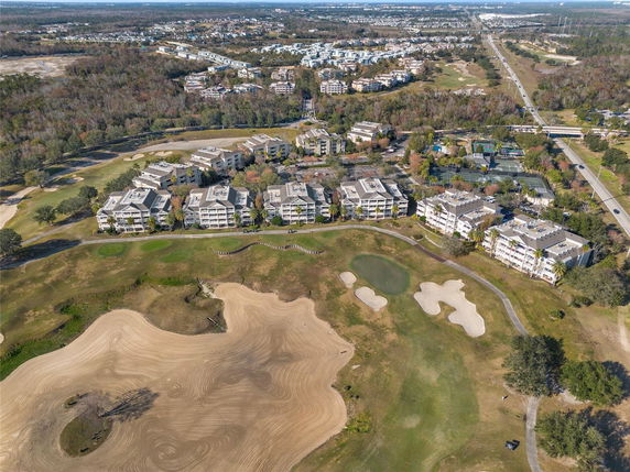 Wide angle view of a residential area with multiple apartment buildings surrounded by a golf course.