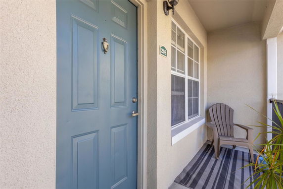 Front view of a house entrance with a blue door and a small porch area.