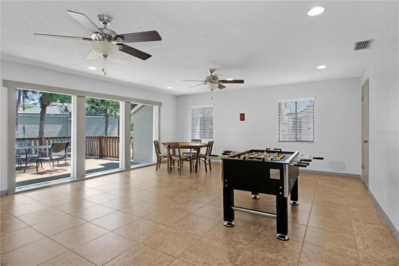 Indoor recreation area with foosball table and seating.