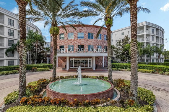 Front view of a multi-story building with a circular entry and fountain.
