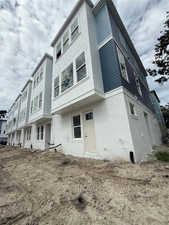 Front view of a multi-story townhouse with a modern design.