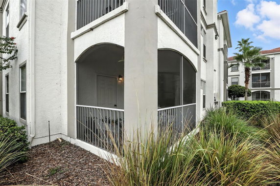 Corner view of a multi-story building with screened balconies.