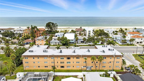 Elevated view overlooking residential buildings near a beach.