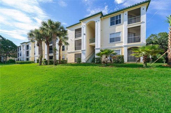 Front view of a three-story apartment building with balconies.