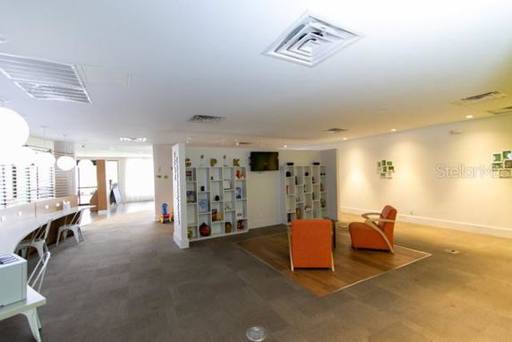 Indoor recreational area with seating and shelving.