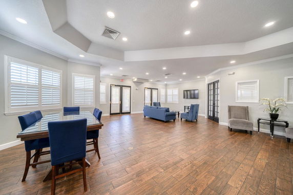 Interior of a recreational room with seating area and table.