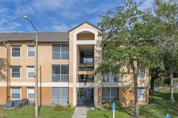 Front view of a three-story apartment building with balconies.