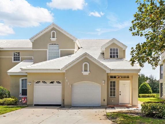 Front view of a two-story house with a gabled roof and double garage.